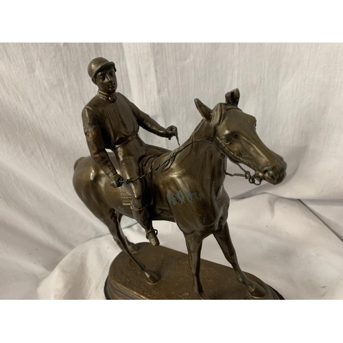 33 - A SPELTER FIGURINE IN THE FORM OF A HORSE AND JOCKEY SIGNED C VALTON