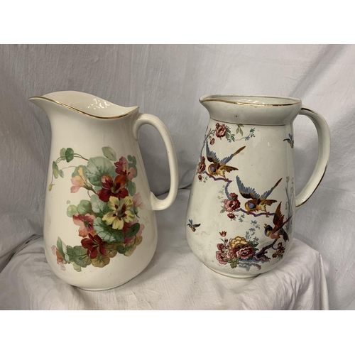 75 - TWO LARGE CERAMIC JUGS ONE WITH FLORAL DECORATION, THE OTHER PEARL POTTERY WITH AVIAN DESIGN H: 31CM