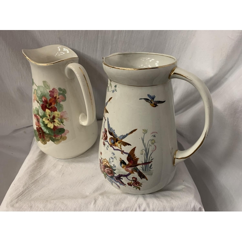 75 - TWO LARGE CERAMIC JUGS ONE WITH FLORAL DECORATION, THE OTHER PEARL POTTERY WITH AVIAN DESIGN H: 31CM