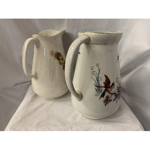 75 - TWO LARGE CERAMIC JUGS ONE WITH FLORAL DECORATION, THE OTHER PEARL POTTERY WITH AVIAN DESIGN H: 31CM