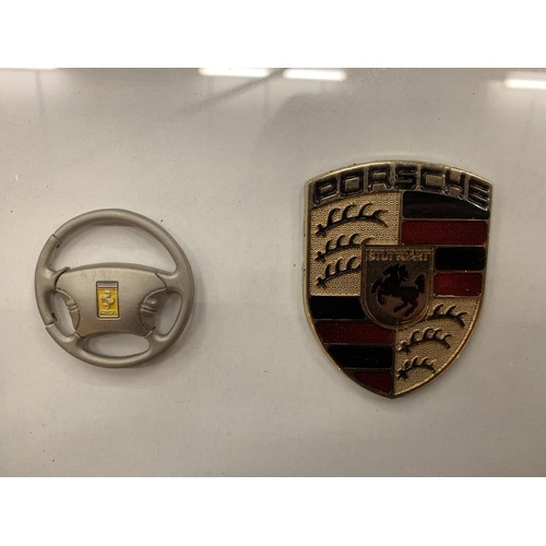 93 - TWO FRAMED CAR BADGES TO INCLUDE FERRARI AND PORSCHE