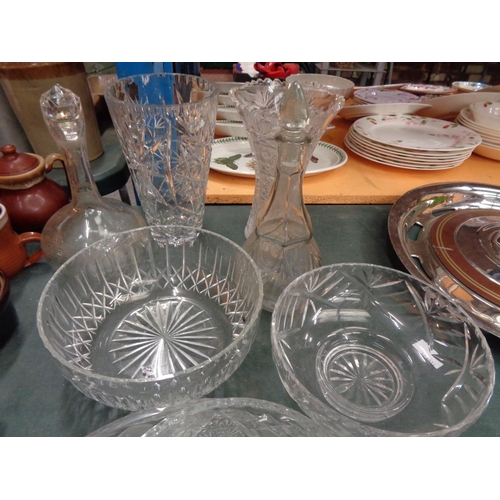 314 - AN ASSORTMENT OF GLASS WARE TO INCLUDE TWO VASES, TWO DECANTERS AND FOUR BOWLS