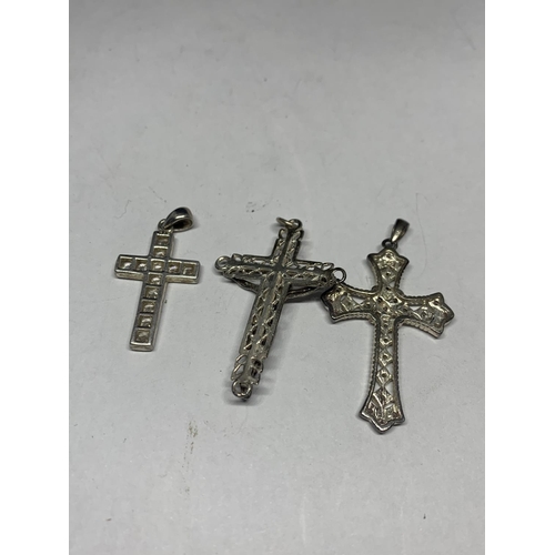 557 - THREE SILVER CROSSES IN A PRESENTATION BOX