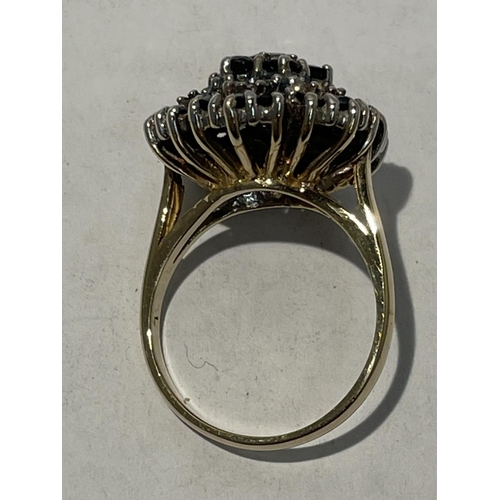 613 - A 9CT GOLD RING WITH THIRTY SAPHIRES AND SEVEN DIAMONDS. SIZE N/O - 5.7GMS