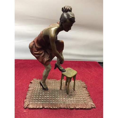 35 - A BERGMAN STYLE COLD PAINTED FIGURINE OF A LADY WITH HER FOOT ON A STOOL HEIGHT APPROXIMATELY 12CM H... 