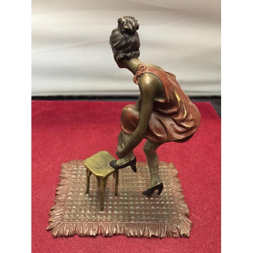 35 - A BERGMAN STYLE COLD PAINTED FIGURINE OF A LADY WITH HER FOOT ON A STOOL HEIGHT APPROXIMATELY 12CM H... 