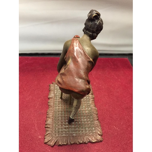 35 - A BERGMAN STYLE COLD PAINTED FIGURINE OF A LADY WITH HER FOOT ON A STOOL HEIGHT APPROXIMATELY 12CM H... 