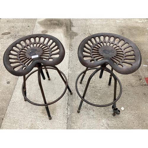 267 - A PAIR OF AGRICULTURAL STYLE TRACTOR SEAT STOOLS +VAT