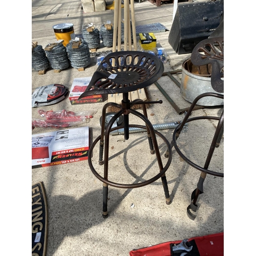 267 - A PAIR OF AGRICULTURAL STYLE TRACTOR SEAT STOOLS +VAT