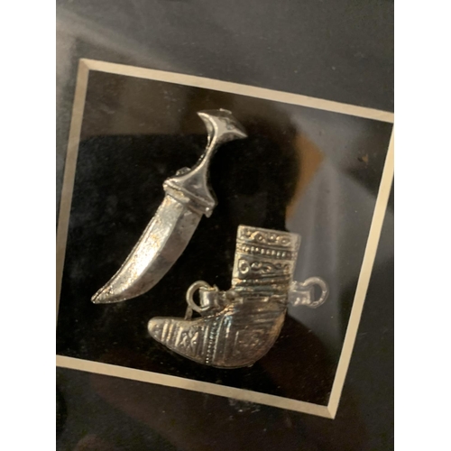 16 - A MINATURE ASIAN SILVER DAGGER AND CASE IN A FRAME