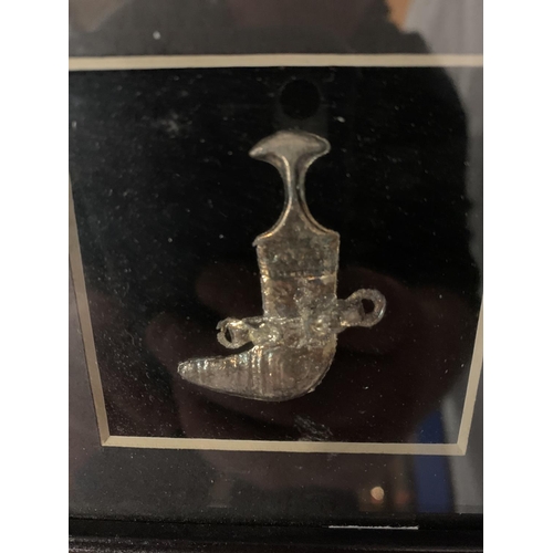 17 - A MINATURE ASIAN SILVER DAGGER IN A FRAME