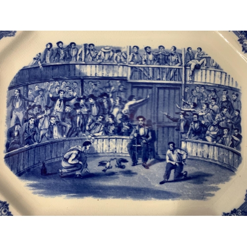 32 - A LARGE BLUE AND WHITE MEAT PLATTER DEPICTING COCK FIGHTING AND STAMPED SPANISH FESTIVITIES 1798