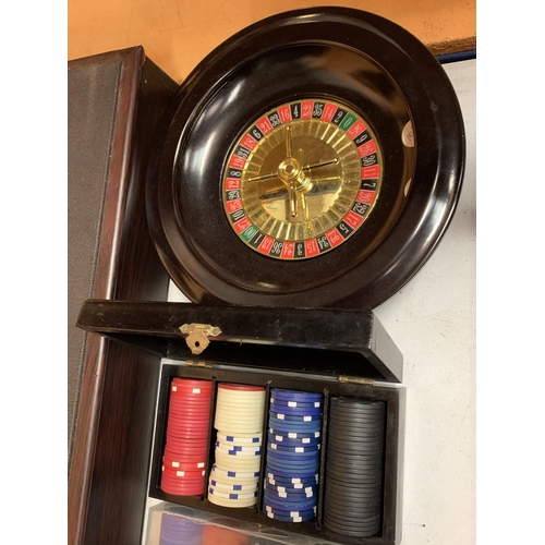 35 - A ROULETTE BOARD WITH WHEEL, CHIPS, DICE ETC