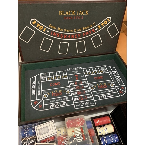 35 - A ROULETTE BOARD WITH WHEEL, CHIPS, DICE ETC