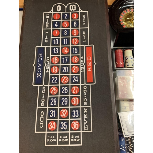 35 - A ROULETTE BOARD WITH WHEEL, CHIPS, DICE ETC