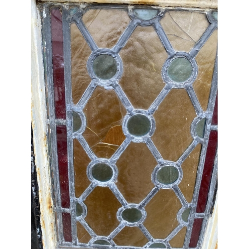 1202A - A PAIR OF TALL CAST IRON WINDOW FRAMES WITH LEADED STAINED GLASS WINDOWS (H:253CM) (SLIGHT DAMAGE TO... 