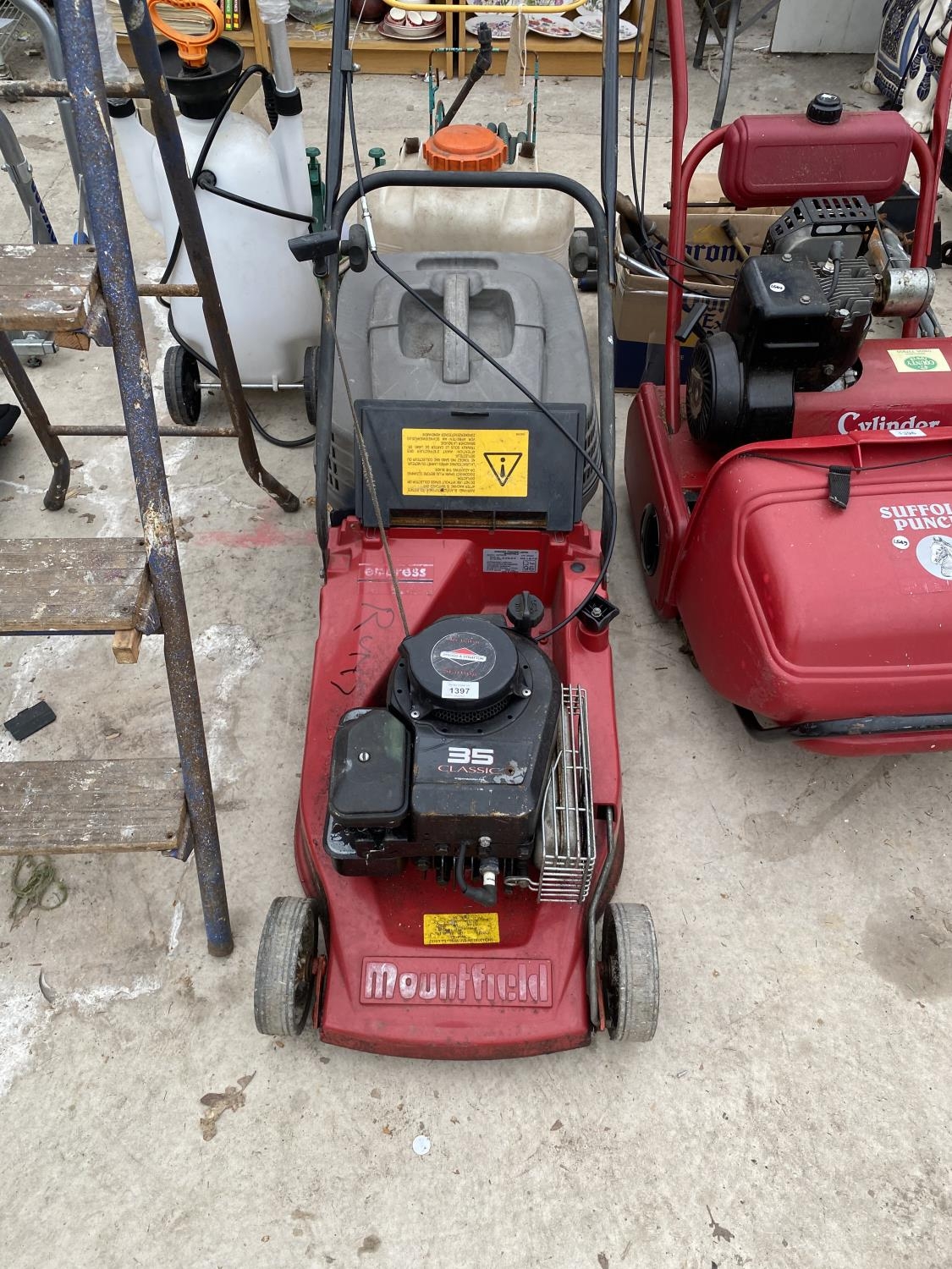 A MOUNTFIELD PETROL LAWN MOWER WITH GRASS BOX AND BRIGGS AND