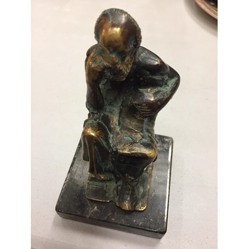 125 - A BRASS FIGURE OF A MAN IN THOUGHT ON A MARBLE BASE