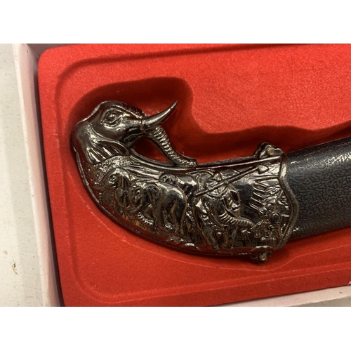 142 - A BOXED ORNATE KNIFE IN AN ELEPHANT DESIGN