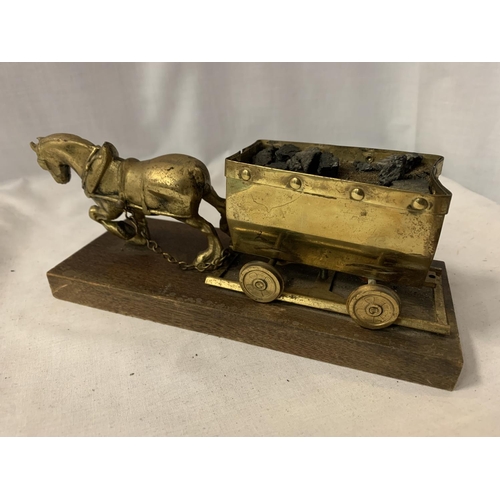 162 - A BRASS HORSE AND COAL WAGON ON A WOODEN BASE