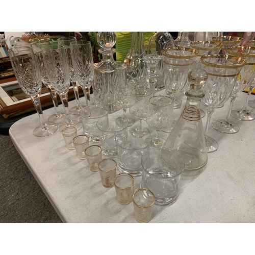 216 - AN ASSORTMENT OF DECORATIVE GLASSWARE TO INCLUDE FIVE DECANTERS, TWO CANDLE STICK HOLDERS AND MULTIP... 