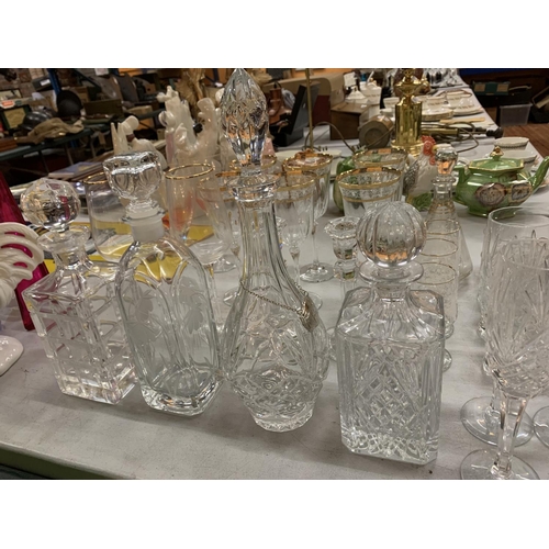 216 - AN ASSORTMENT OF DECORATIVE GLASSWARE TO INCLUDE FIVE DECANTERS, TWO CANDLE STICK HOLDERS AND MULTIP... 