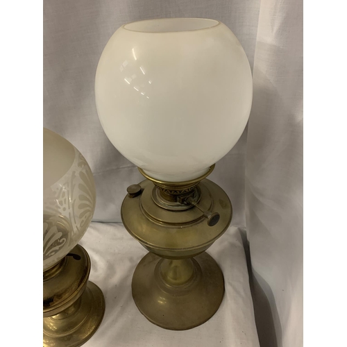 224 - TWO BRASS OIL LAMPS, AN ETCHED GLASS LAMP SHADE AND FURTHER MILK GLASS SHADE