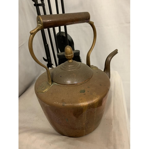 227 - A COPPER KETTLE AND A WROUGHT IRON FIRESIDE COMPANION SET