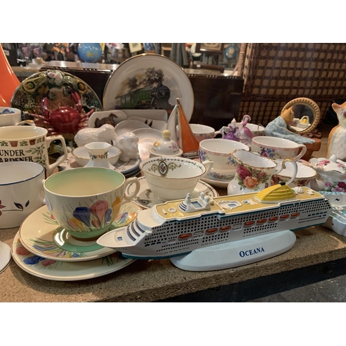 254 - A LARGE ASSORTMENT OF CERAMICS TO INCLUDE MUGS, DECORATIVE PLATES ETC