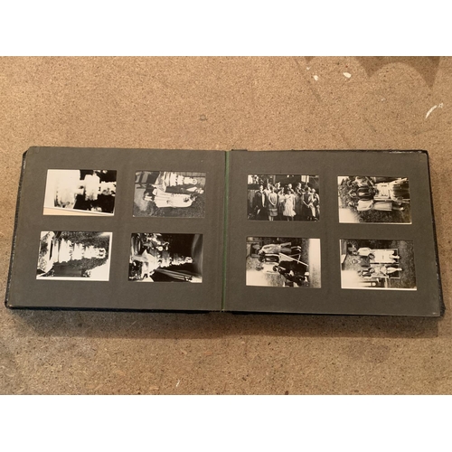 257 - A SMALL VINTAGE PHOTO ALBUM CONTAINING BLACK AND WHITE IMAGES