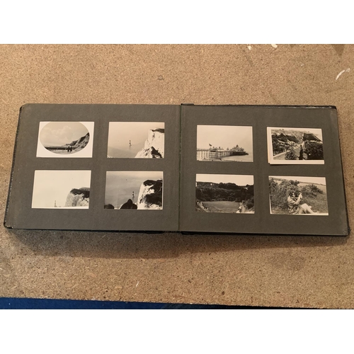 257 - A SMALL VINTAGE PHOTO ALBUM CONTAINING BLACK AND WHITE IMAGES