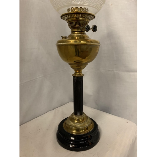 294 - A BRASS AND GLASS OIL LAMP ON A METAL BASE WITH A GLASS DECORATIVE SHADE   H: 69CM