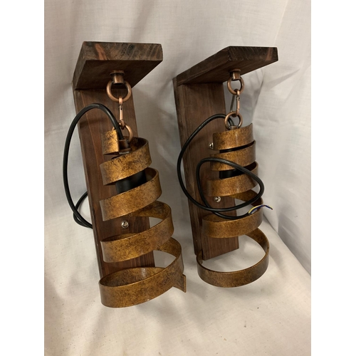 242 - TWO WOOD MOUNTED WALL LIGHTS WITH METAL SPIRAL BRONZE COLOURED SHADES