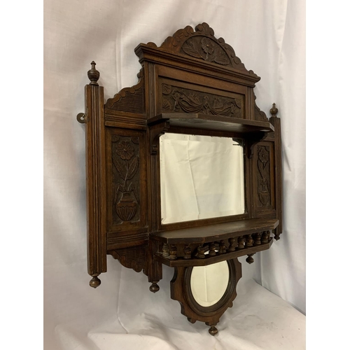 48A - AN ORNATE CARVED WALL HANGING WITH A RECTANGULAR AND A SMALLER MIRROR AND TWO SHELVES