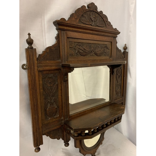 48A - AN ORNATE CARVED WALL HANGING WITH A RECTANGULAR AND A SMALLER MIRROR AND TWO SHELVES