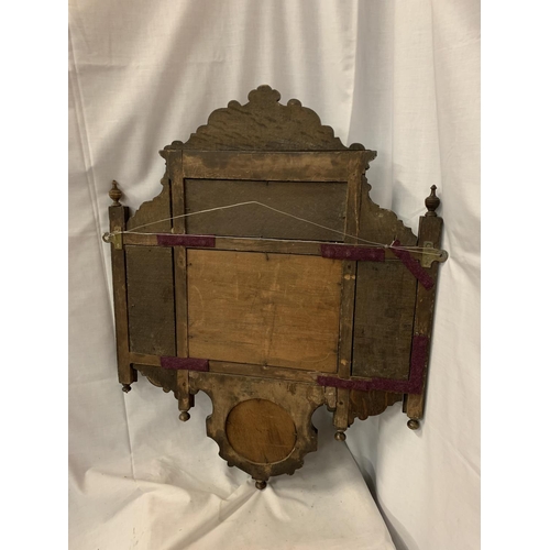 48A - AN ORNATE CARVED WALL HANGING WITH A RECTANGULAR AND A SMALLER MIRROR AND TWO SHELVES