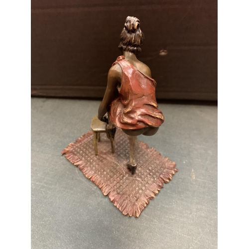 198 - AN ART DECO STYLE COLD PAINTED BRONZE OF A LADY WITH HER FOOT UP ON A STOOL