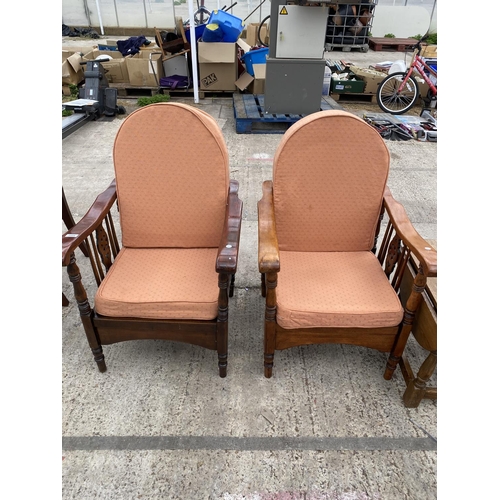 2459 - A PAIR OF MID 20TH CENTURY RECLINING CHAIRS WITH WHEEL BACKS