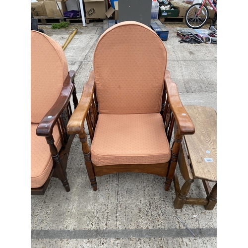 2459 - A PAIR OF MID 20TH CENTURY RECLINING CHAIRS WITH WHEEL BACKS