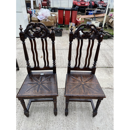 2470 - A PAIR OF JACOBEAN STYLE OAK HALL CHAIRS