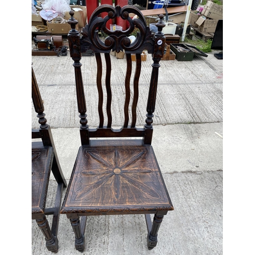 2470 - A PAIR OF JACOBEAN STYLE OAK HALL CHAIRS