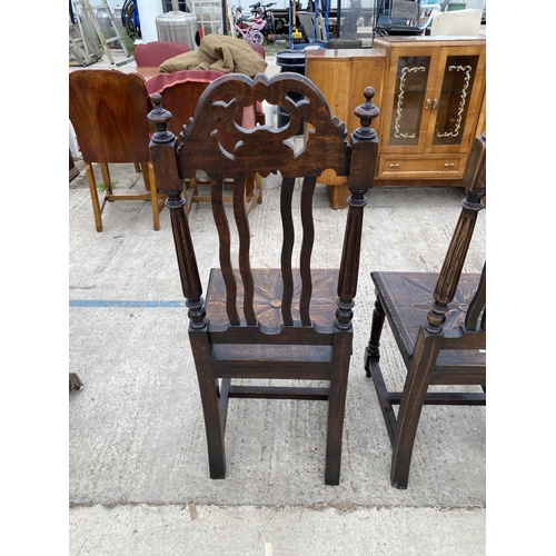 2470 - A PAIR OF JACOBEAN STYLE OAK HALL CHAIRS