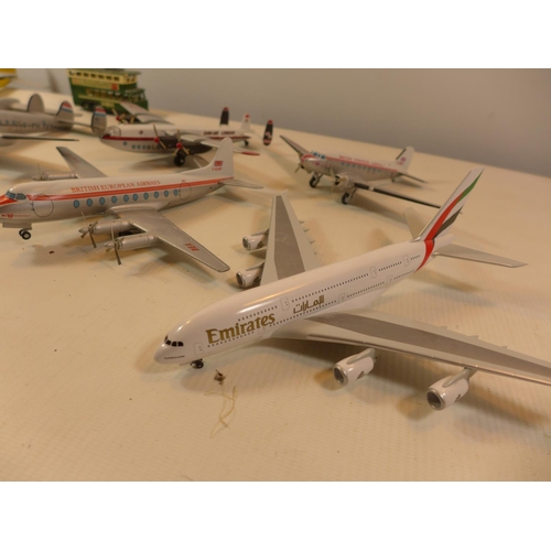 455 - SEVEN PAINTED MODEL PLANES AND A BUS