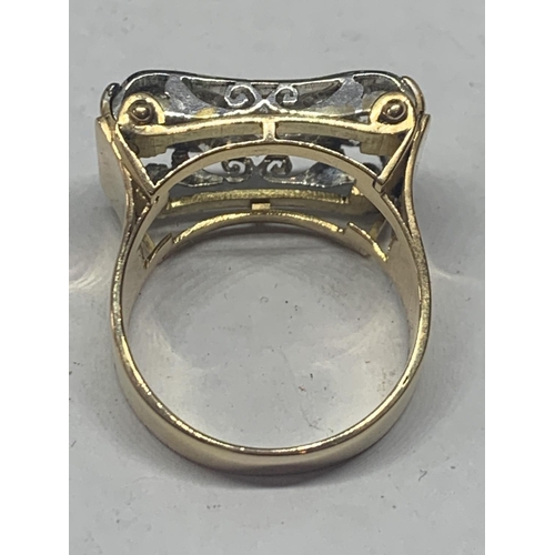 601 - A HEAVY 18 CARAT GOLD RING WITH FIFTEEN DIAMONDS SET IN A RECTANGLE OF DIAMOND CHIPS GROSS WEIGHT 13... 