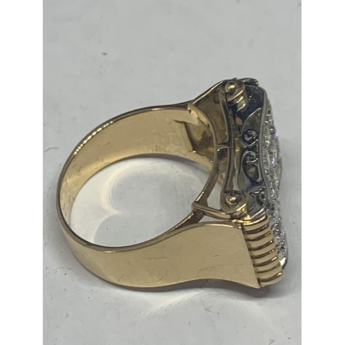 601 - A HEAVY 18 CARAT GOLD RING WITH FIFTEEN DIAMONDS SET IN A RECTANGLE OF DIAMOND CHIPS GROSS WEIGHT 13... 