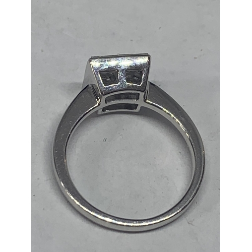 602 - AN 18 CARAT WHITE GOLD RING WITH SIXTEEN DIAMONDS SET IN A SQUARE GROSS WIEGHT 3.9 GRAMS SIZE L/M WI... 