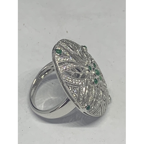 606 - AN 18 CARAT WHITE GOLD DIAMOND AND EMERALD COCKTAIL RING GROSS WEIGHT 13.2 GRAMS SIZE O/P