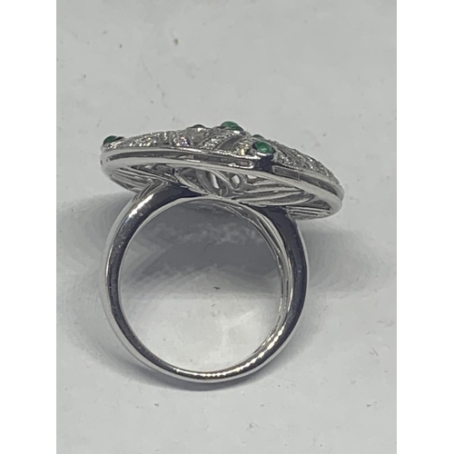 606 - AN 18 CARAT WHITE GOLD DIAMOND AND EMERALD COCKTAIL RING GROSS WEIGHT 13.2 GRAMS SIZE O/P