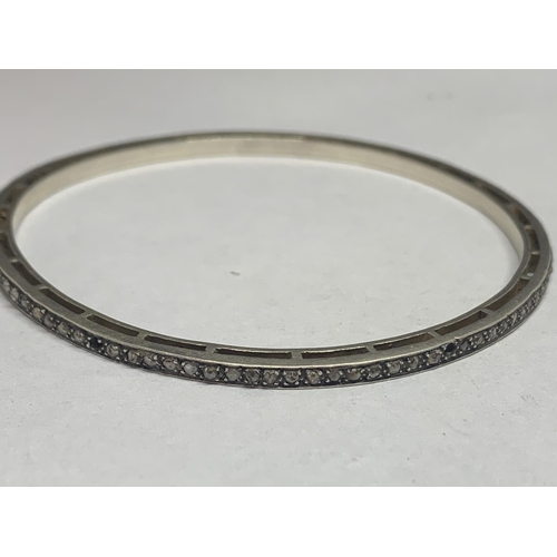 670 - A SILVER BANGLE WITH DIAMOND CHIPS (SOME MISSING)