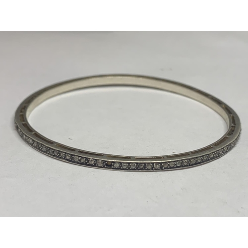 670 - A SILVER BANGLE WITH DIAMOND CHIPS (SOME MISSING)